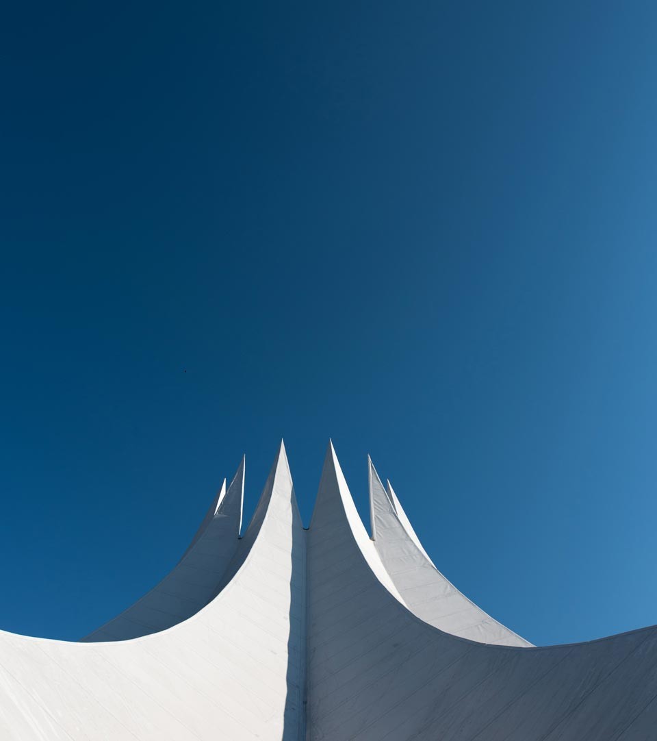 Abstract white structure against a deep blue cloudless sky